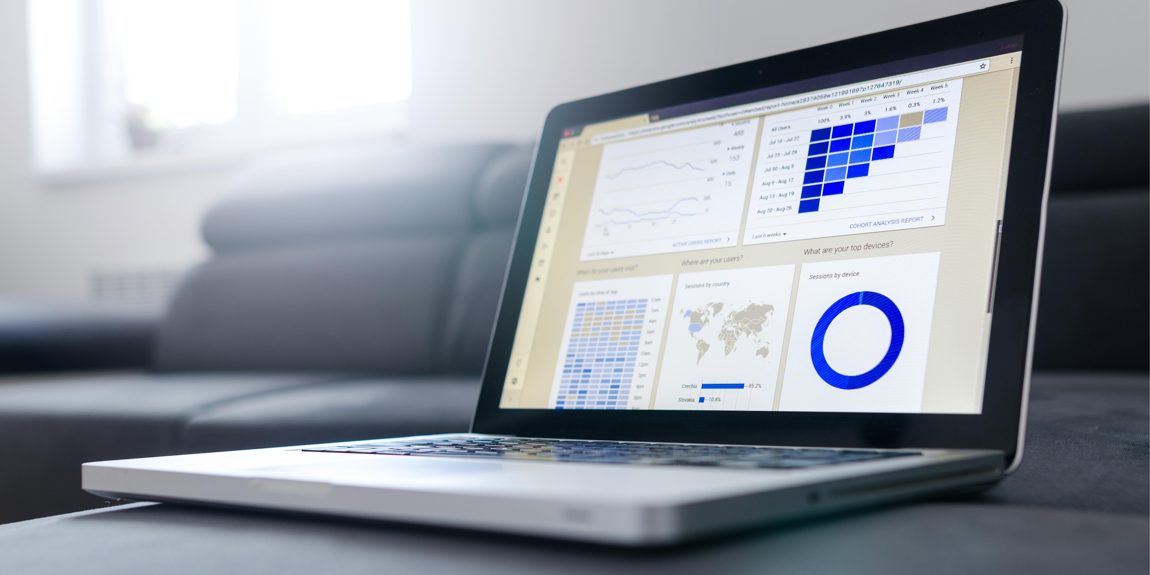 SEO specialist analyzing website performance metrics and search engine optimization data on a laptop dashboard.